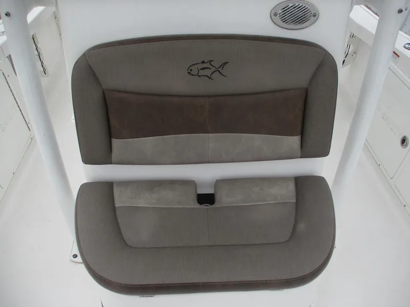 Slide: The Image of 2020 Crevalle 26 HCO boat seat with fish logo, featuring brown and gray upholstery. - 16