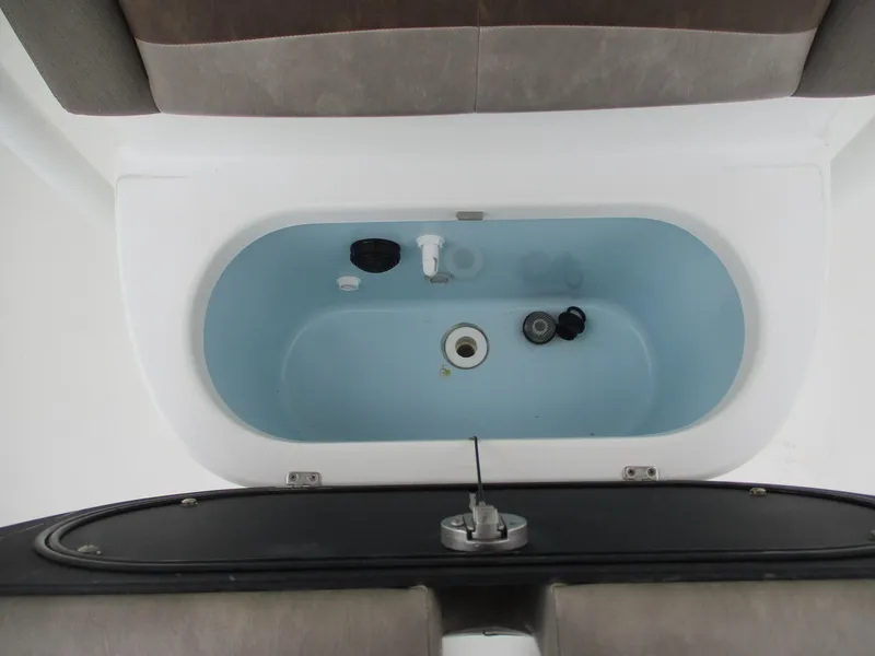 Slide: The Image of Livewell compartment in a 2020 Crevalle 26 HCO boat, featuring a clean interior design. - 17