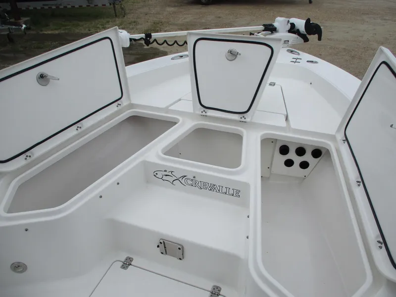 Slide: The Image of 2020 Crevalle 26 HCO boat deck with open storage compartments and trolling motor. - 21