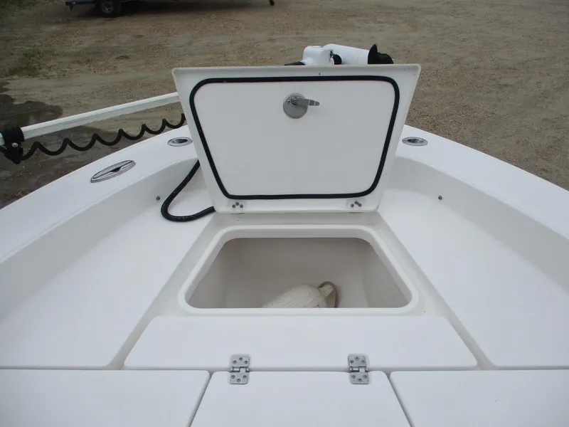 Slide: The Image of 2020 Crevalle 26 HCO boat storage compartment with open hatch, showcasing interior space. - 22