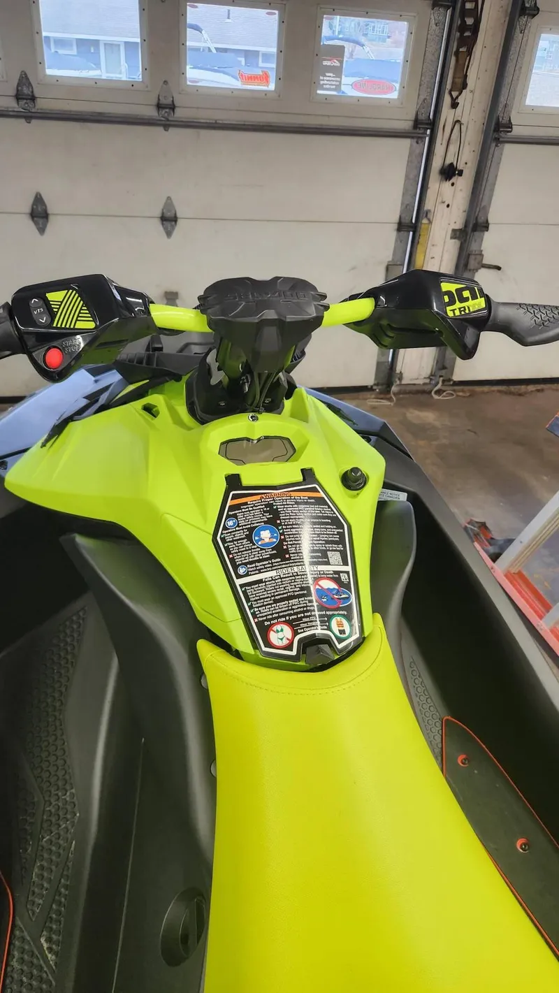 Slide: The Image of 2023 Sea-Doo SPARK 3UP TRIXX SS in a garage, vibrant yellow-green color. - 5