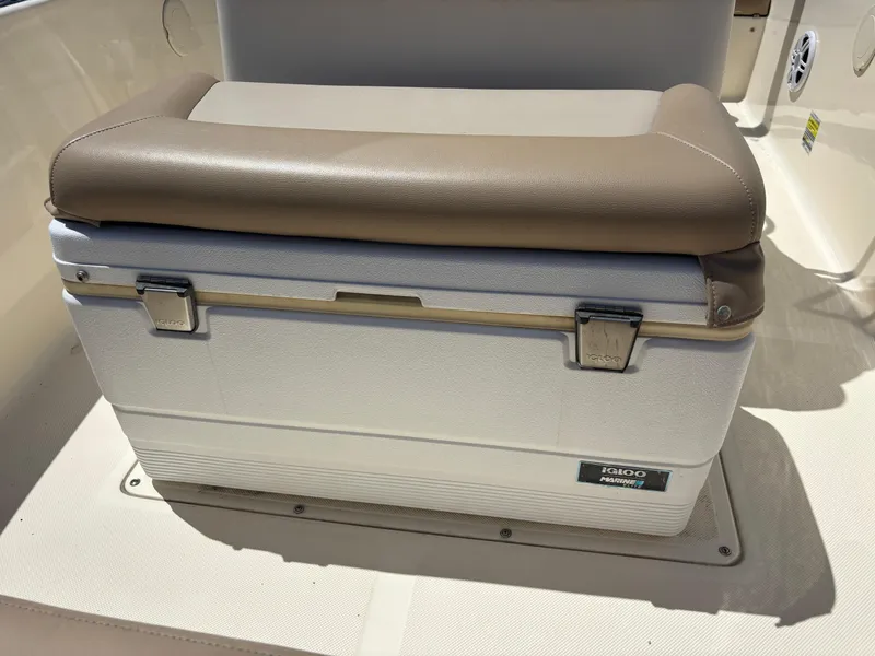 Slide: The Image of 2022 Scout 175 Sportfish boat seat with integrated cooler, featuring a cushioned top. - 11