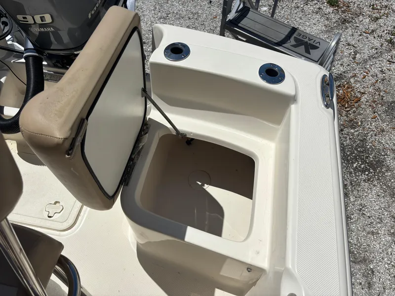 Slide: The Image of 2022 Scout 175 Sportfish boat interior with open storage compartment and Yamaha 90 engine. - 12