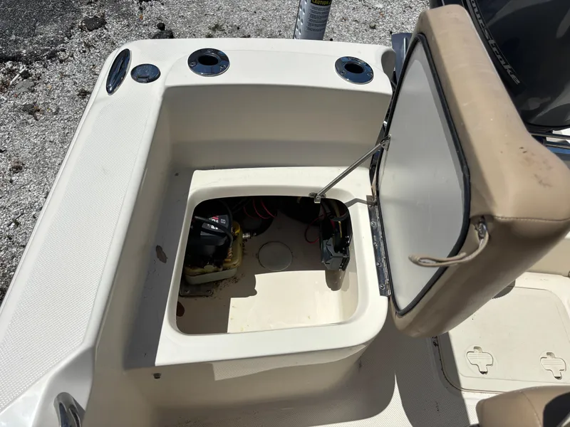 Slide: The Image of 2022 Scout 175 Sportfish boat storage compartment with open hatch, revealing interior details. - 13