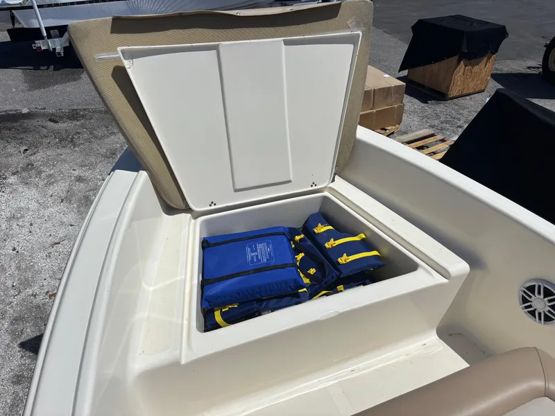 Slide: The Image of 2022 Scout 175 Sportfish boat storage compartment with life jackets inside. - 16