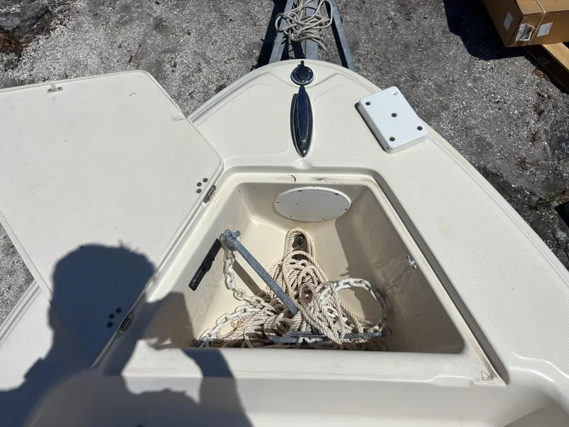 Slide: The Image of 2022 Scout 175 Sportfish boat anchor storage with rope on deck. - 18