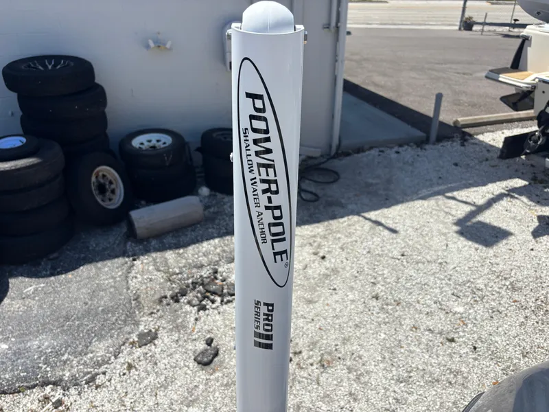 Slide: The Image of Power-Pole shallow water anchor near Scout 175 Sportfish 2022, with tires in the background. - 19