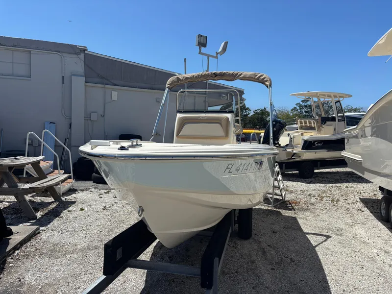 Slide: The Image of 2022 Scout 175 Sportfish boat on display in a sunny outdoor setting. - 3