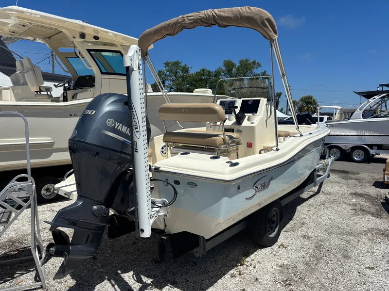 Slide: The Image of 2022 Scout 175 Sportfish boat with Yamaha engine, parked on a trailer. - 4