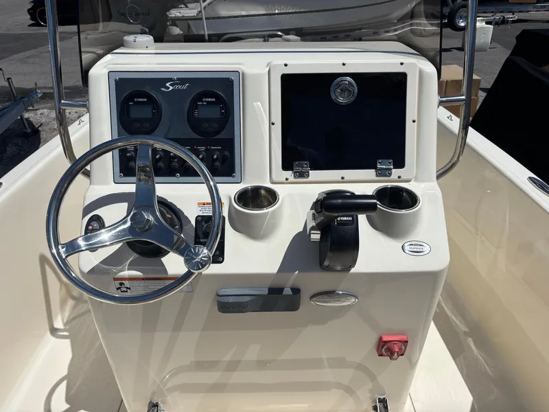 Slide: The Image of 2022 Scout 175 Sportfish boat console with steering wheel and controls. - 6
