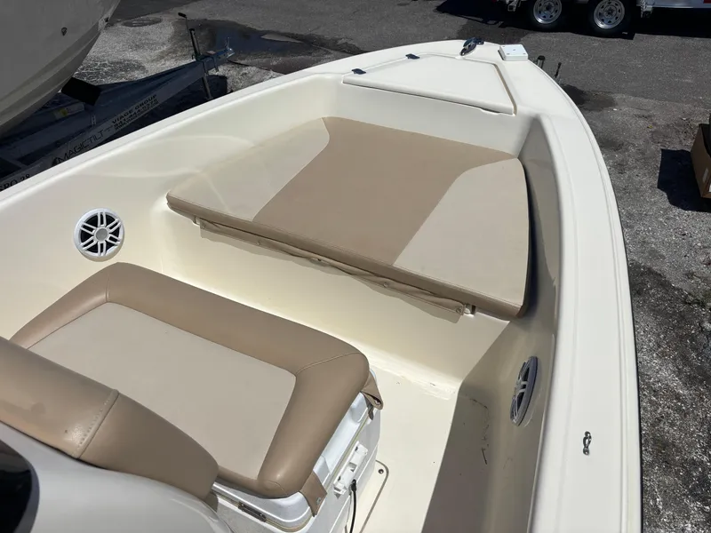 Slide: The Image of 2022 Scout 175 Sportfish boat interior with beige seating and speakers. - 9