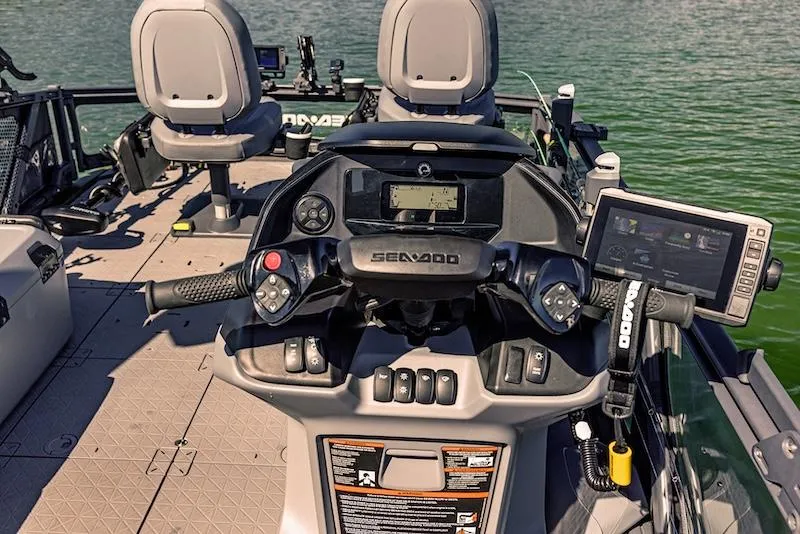Slide: The Image of 2025 Sea-Doo Switch Fish 18 dashboard with advanced controls and navigation system on water. - 7