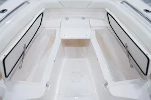 Slide: The Image of 2025 Grady-White Canyon 271 boat interior with dual seats and storage compartments. - 4