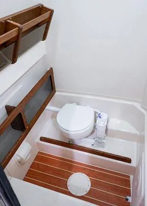 Slide: The Image of 2025 Grady-White Canyon 271 boat interior with dual engines in a showroom. - 6