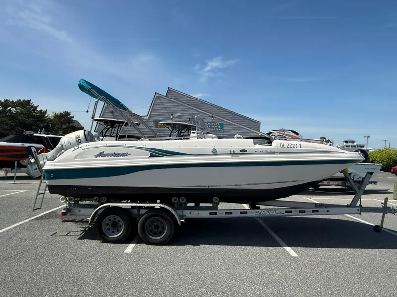 Slide: The Image of 2002 Hurricane Fun Deck GS211 boat on trailer in parking lot. - 0