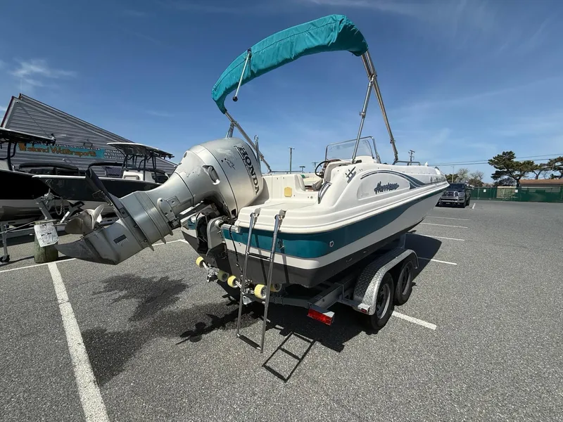 Slide: The Image of 2002 Hurricane Fun Deck GS211 boat on trailer with outboard motor and canopy. - 10