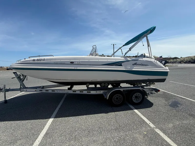 Slide: The Image of 2002 Hurricane Fun Deck GS211 boat on trailer in parking lot. - 2