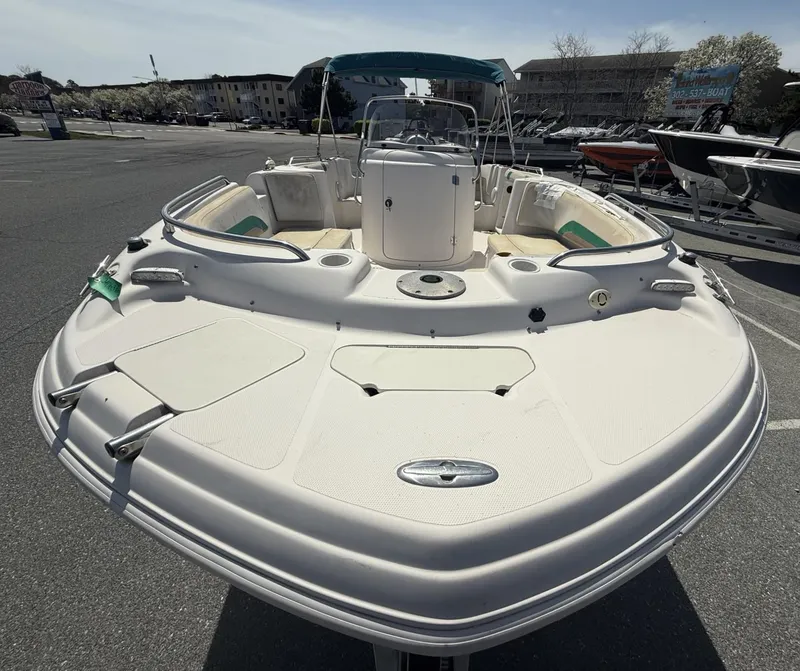 Slide: The Image of 2002 Hurricane Fun Deck GS211 boat with spacious deck, parked in a marina. - 3