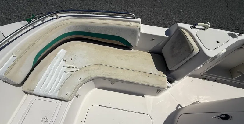 Slide: The Image of 2002 Hurricane Fun Deck GS211 boat interior with white and green seating. - 5
