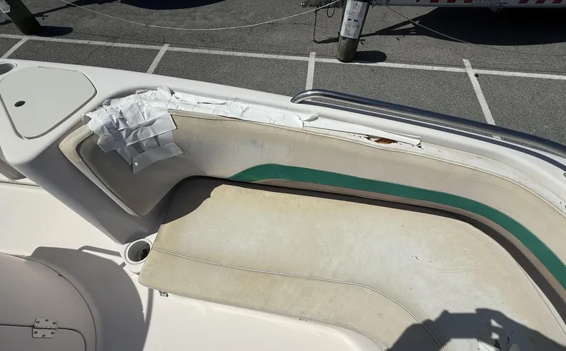 Slide: The Image of 2002 Hurricane Fun Deck GS211 boat interior with worn seating and cup holder. - 6