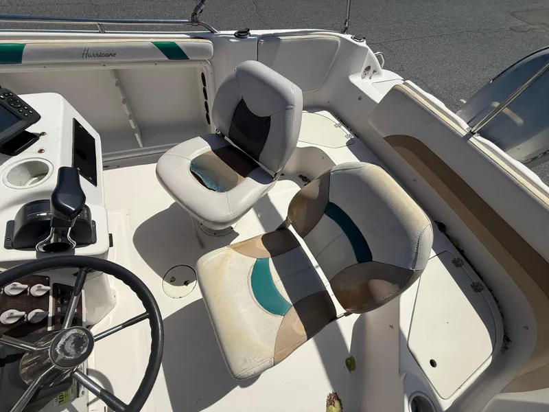 Slide: The Image of 2002 Hurricane Fun Deck GS211 boat interior with dual seats and steering wheel. - 7