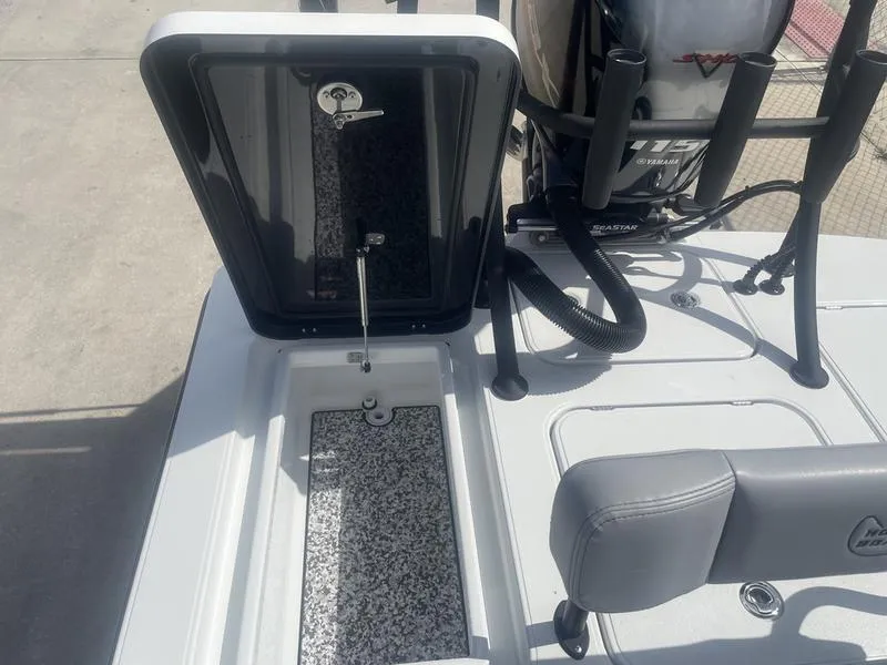 Slide: The Image of 2024 Islamorada Boatworks Morada 18 interior with open storage compartment and Yamaha outboard motor. - 10