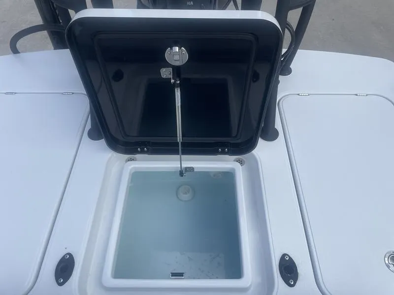 Slide: The Image of 2024 Islamorada Boatworks Morada 18 livewell with open lid, showcasing interior design. - 11