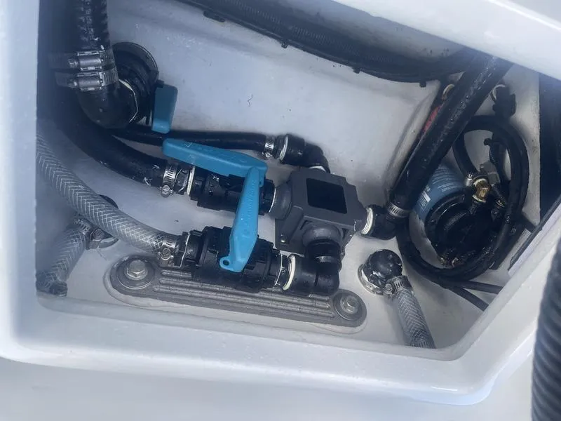 Slide: The Image of 2024 Islamorada Boatworks Morada 18 plumbing system with blue valve and hoses. - 12