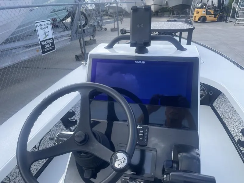Slide: The Image of 2024 Islamorada Boatworks Morada 18 dashboard with steering wheel and navigation display. - 14