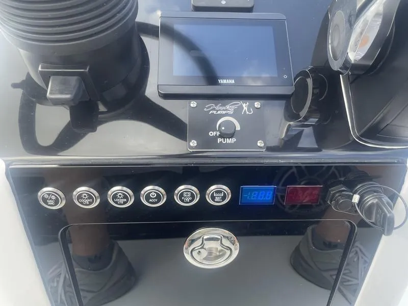 Slide: The Image of 2024 Islamorada Boatworks Morada 18 dashboard with controls and Yamaha display. - 15