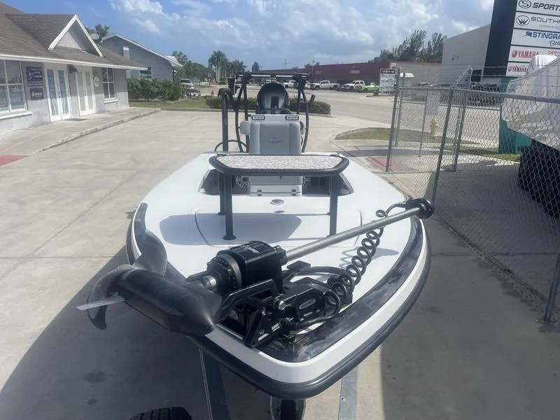 Slide: The Image of 2024 Islamorada Boatworks Morada 18 on trailer, featuring a trolling motor, parked outdoors. - 3