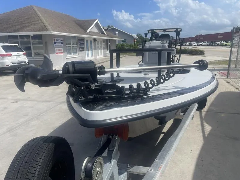 Slide: The Image of 2024 Islamorada Boatworks Morada 18 on trailer, parked outside dealership under clear sky. - 4
