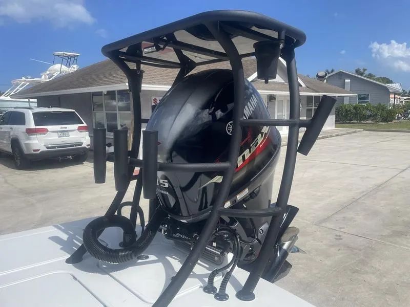 Slide: The Image of 2024 Islamorada Boatworks Morada 18 with Yamaha outboard motor, parked outdoors. - 5