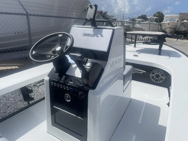 Slide: The Image of 2024 Islamorada Boatworks Morada 18 console with steering wheel and navigation system. - 6