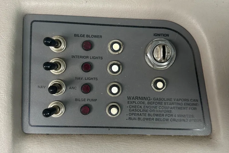 Slide: The Image of Control panel of a 2002 Cobalt 246 boat with ignition and switches. - 14