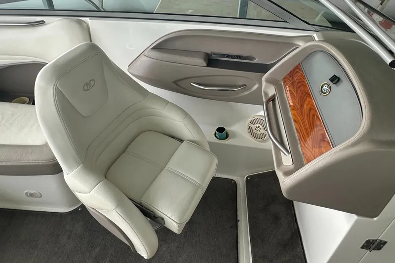 Slide: The Image of Interior of a 2002 Cobalt 246 boat featuring a captain's chair and dashboard. - 16