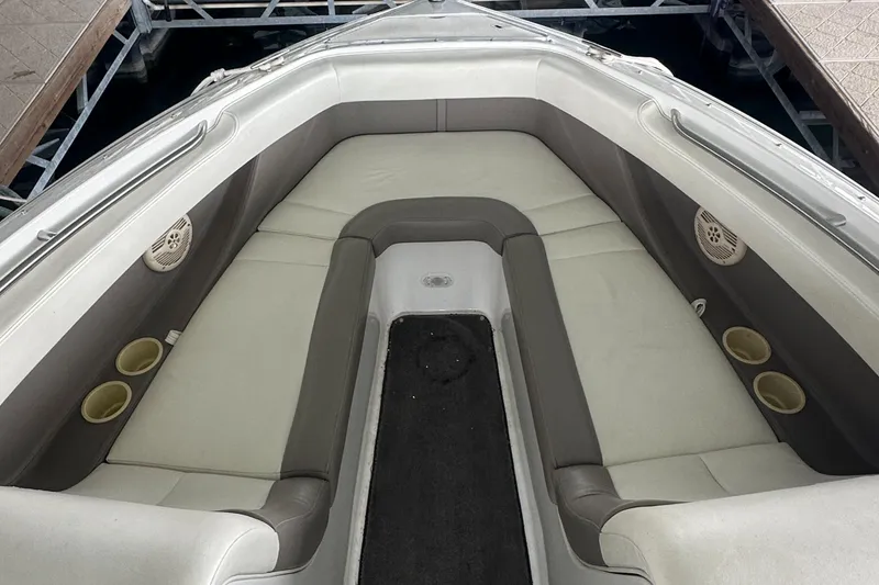 Slide: The Image of 2002 Cobalt 246 boat interior with cushioned seating and cup holders. - 17