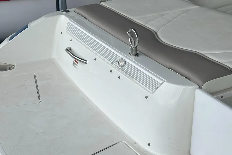 Slide: The Image of Rear view of a 2002 Cobalt 246 boat with white and beige seating. - 27