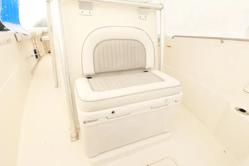 Slide: The Image of 2009 Sailfish 2660 boat interior with cushioned seating and storage compartment. - 11