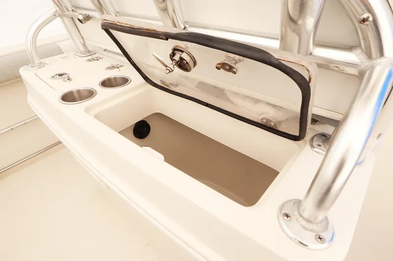 Slide: The Image of 2009 Sailfish 2660 boat storage compartment with open lid and cup holders. - 14