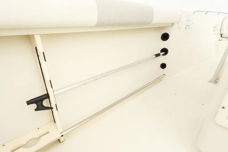 Slide: The Image of 2009 Sailfish 2660 boat interior with rod holders and cushioned seating. - 16