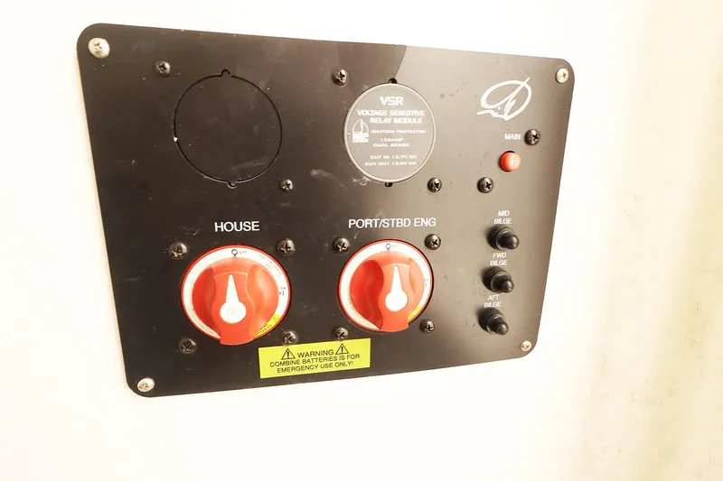 Slide: The Image of Control panel of a 2009 Sailfish 2660 boat with switches and warning label. - 18