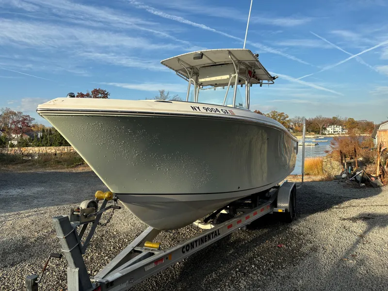 Slide: The Image of 2009 Sailfish 2660 boat on trailer, parked outdoors under clear sky. - 3