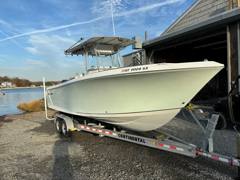 Slide: The Image of 2009 Sailfish 2660 boat on trailer near waterfront building. - 4