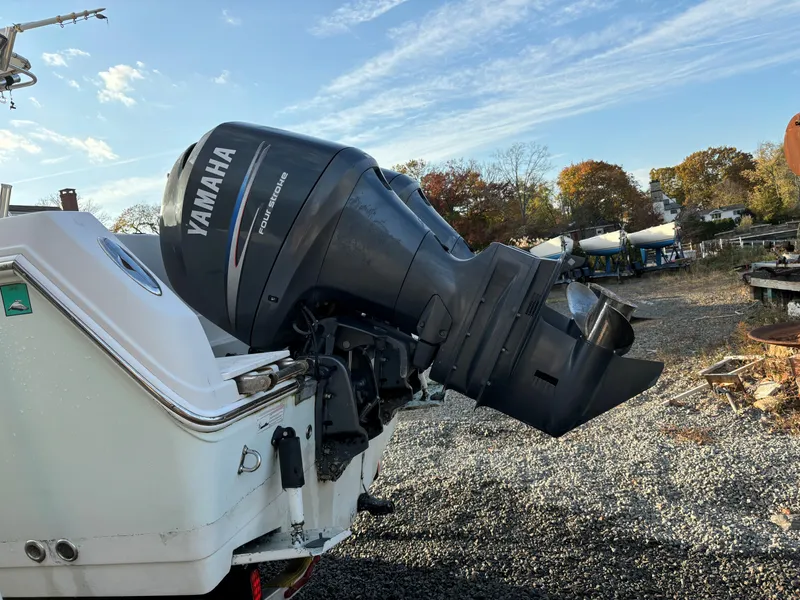 Slide: The Image of 2009 Sailfish 2660 boat with Yamaha outboard motor in a gravel yard. - 6