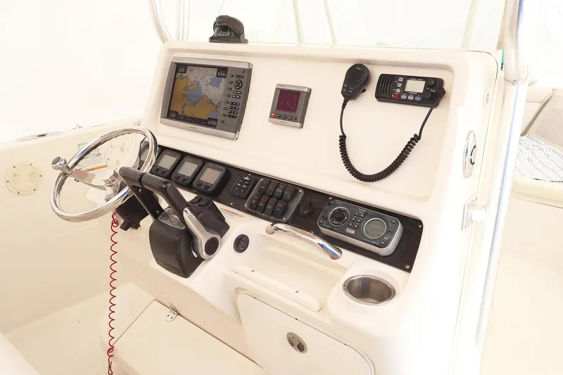 Slide: The Image of 2009 Sailfish 2660 boat console with steering wheel, navigation equipment, and communication devices. - 8