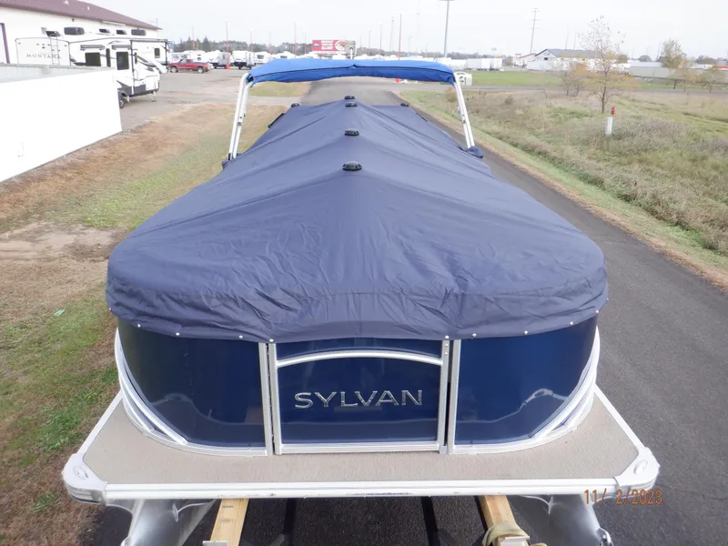 Slide: The Image of 2013 Sylvan Signature 8523 LZ pontoon boat with blue cover on a trailer. - 10