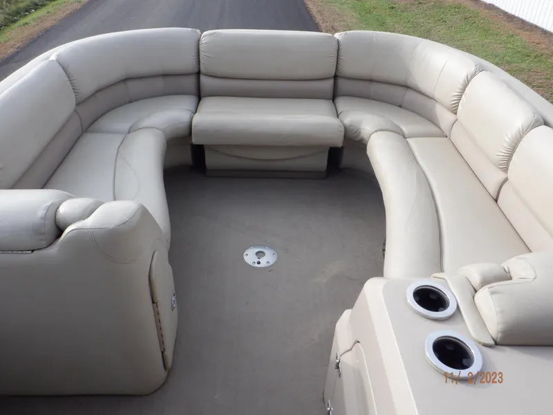 Slide: The Image of 2013 Sylvan Signature 8523 LZ boat interior with beige seating and cup holders. - 13