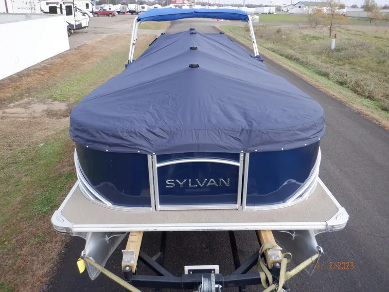 Slide: The Image of 2013 Sylvan Signature 8523 LZ pontoon boat with blue cover on a trailer. - 15