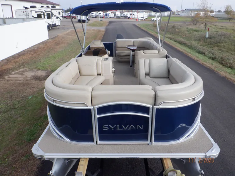 Slide: The Image of 2013 Sylvan Signature 8523 LZ pontoon boat with beige seating and blue exterior. - 17